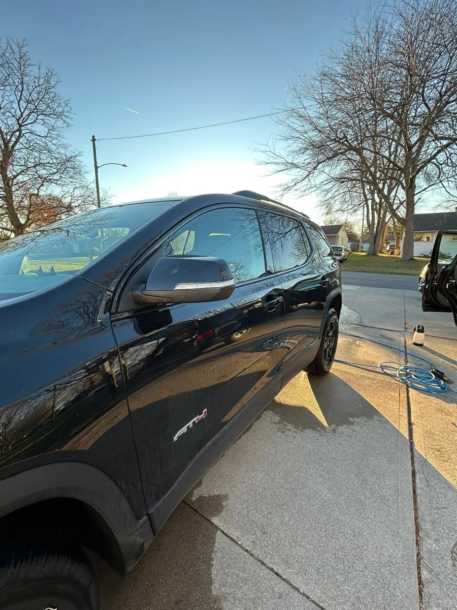 Black GMC Acadia profile after a wash