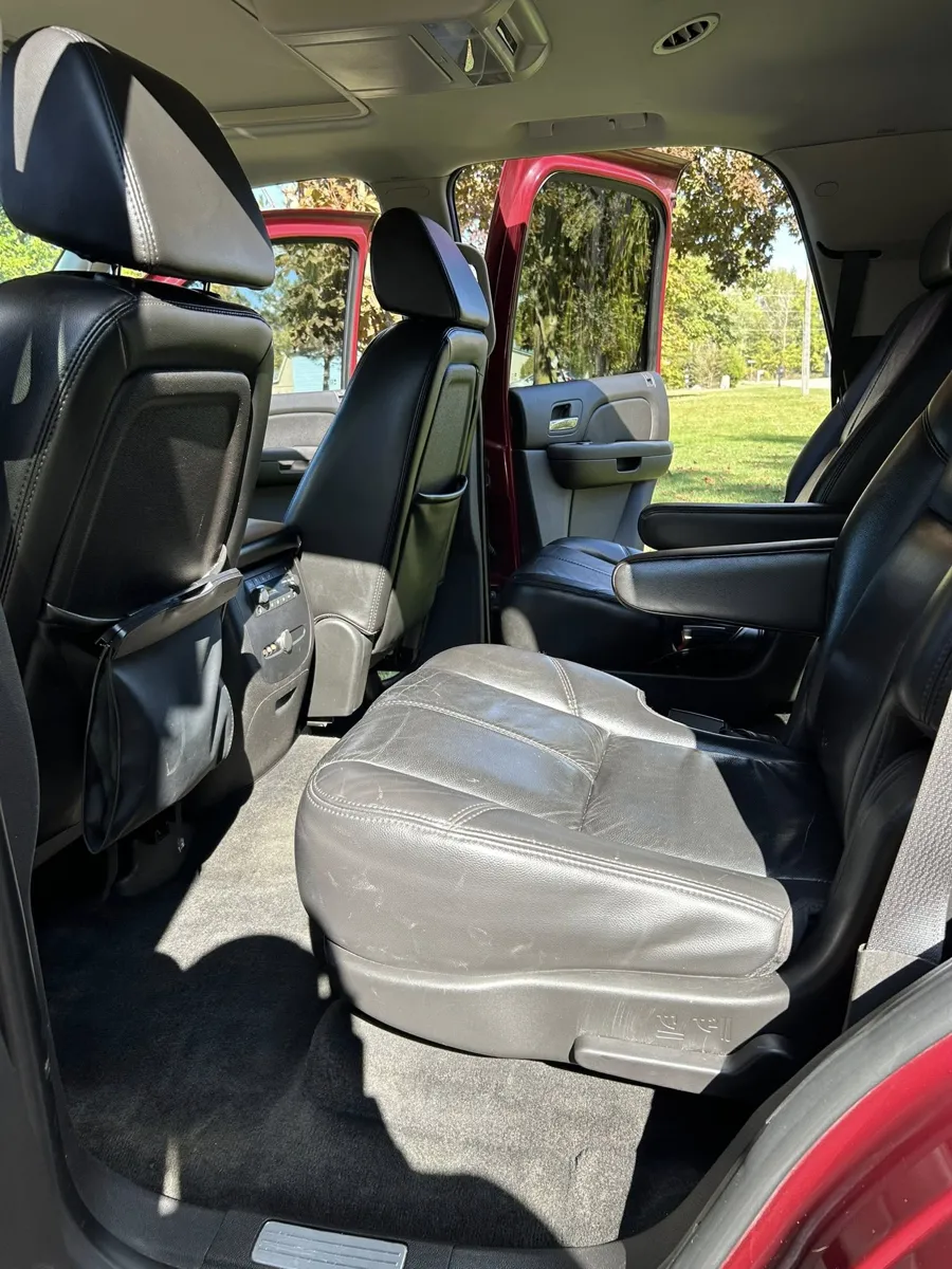 Maroon Chevy Tahoe rear leather seats after detailing