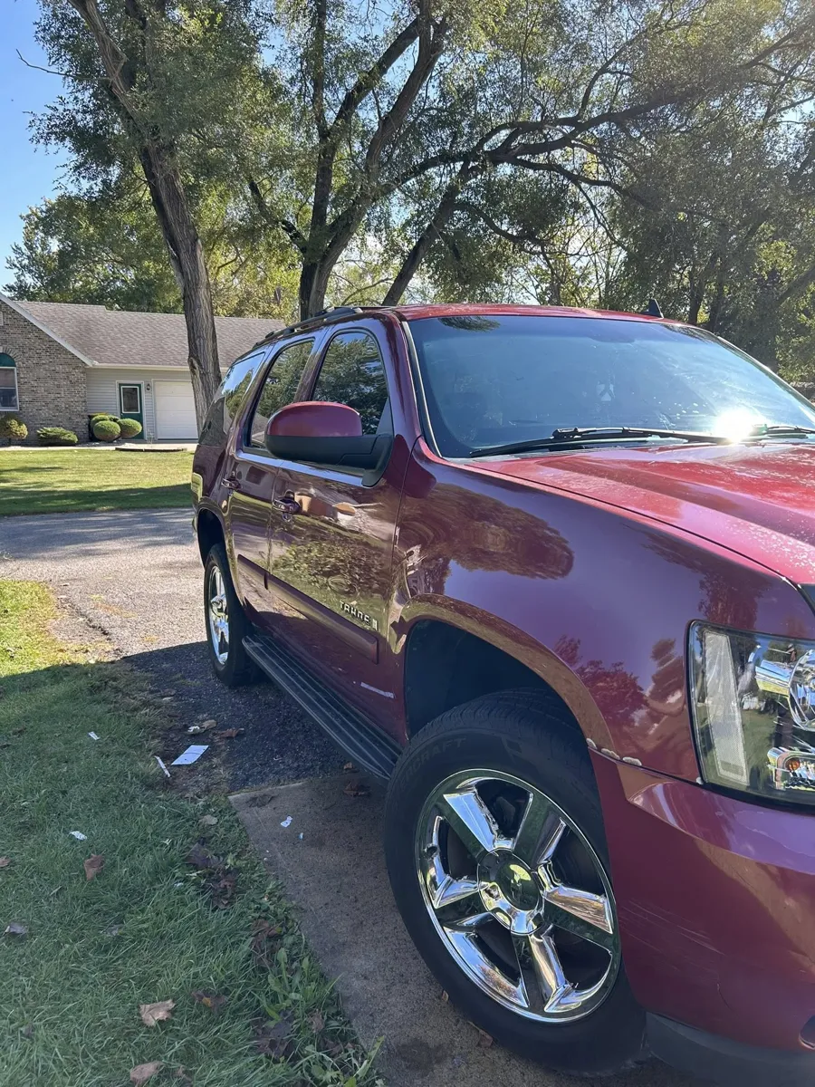 Maroon Chevy Tahoe side shine